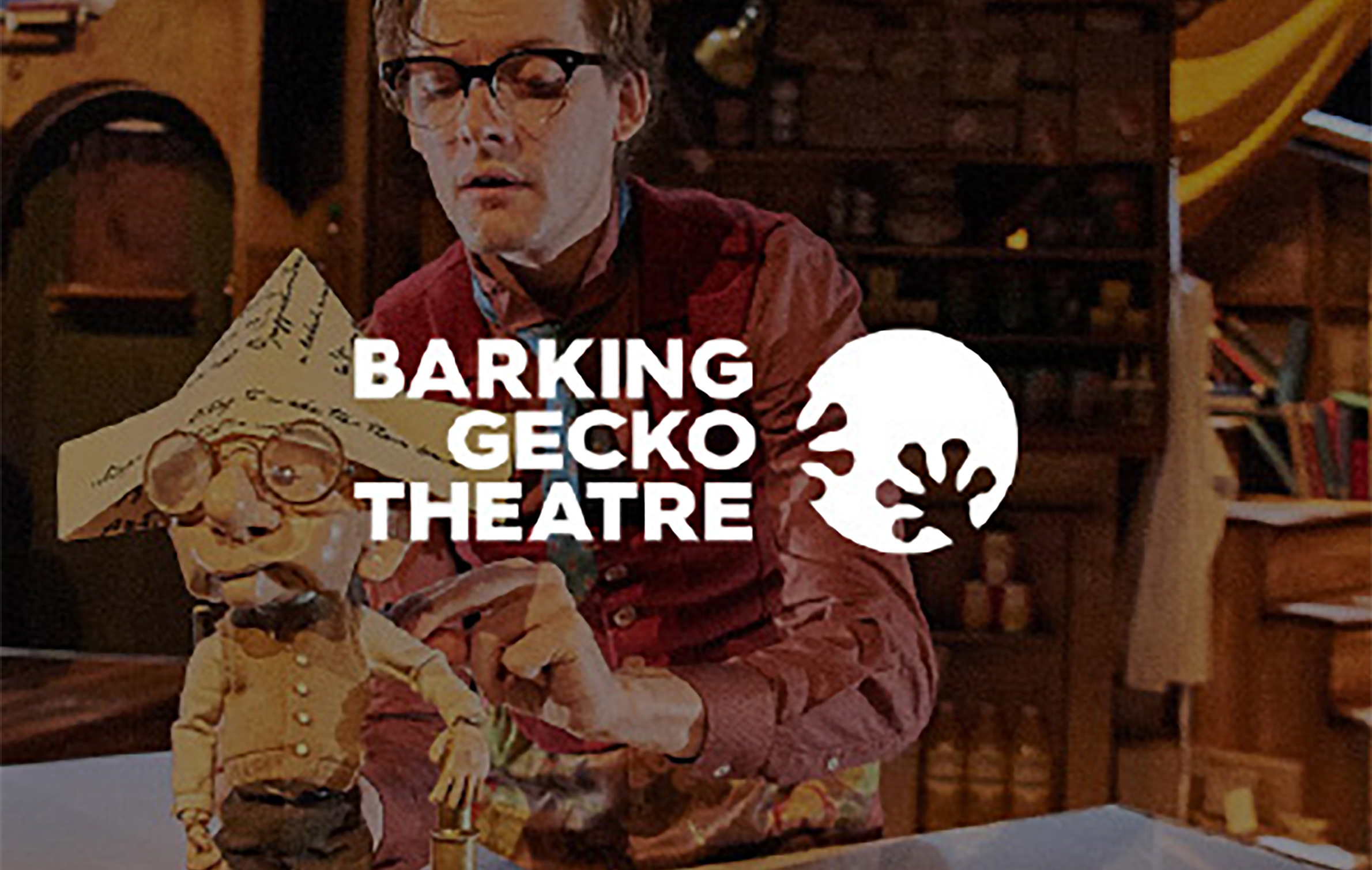 Theatrical stage set behind Barking Gecko logo